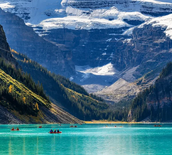 Lake Louise turquoise lake with canoes and glacier mountain views in Banff National Park