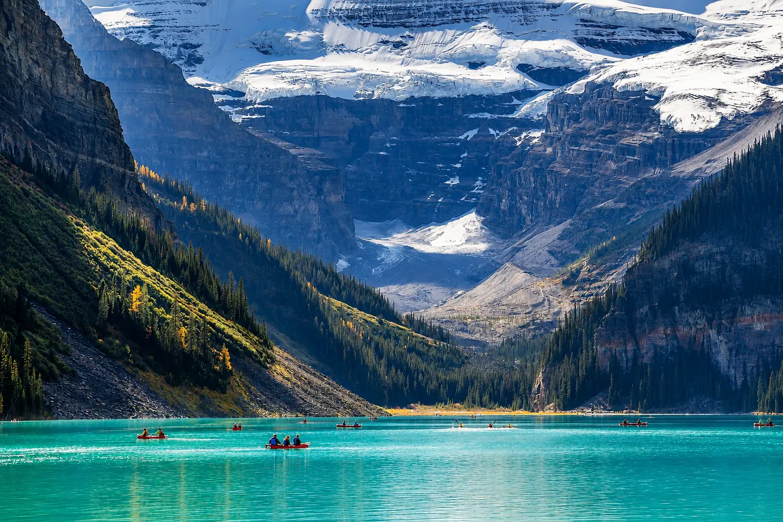 Lake Louise turquoise lake with canoes and glacier mountain views in Banff National Park